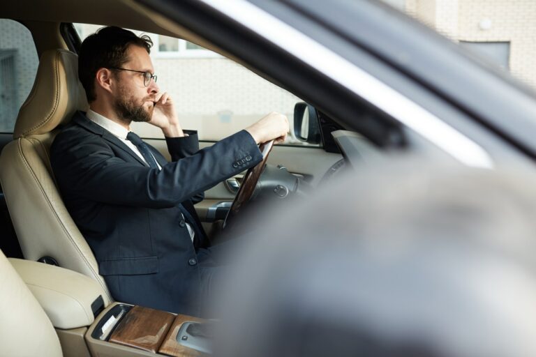 Businessman sitting in his luxury car